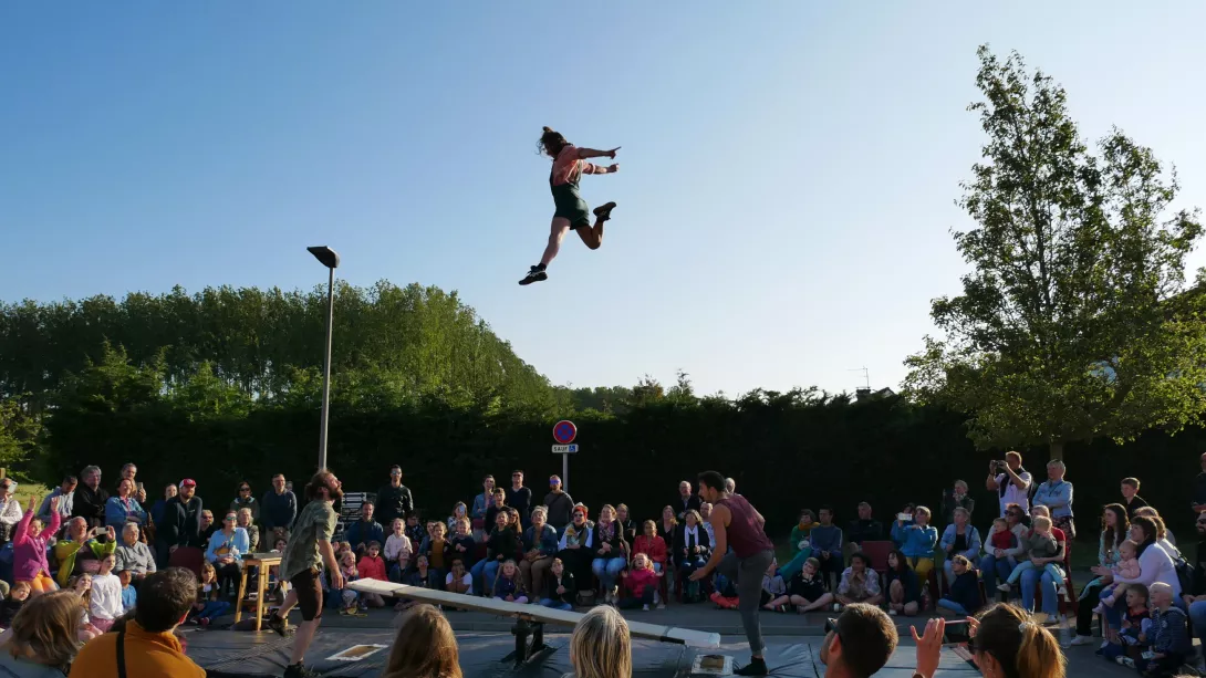 Circassienne pendant un saut entourée d'une foule 